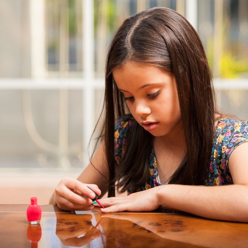 child painting nails to stop nail-biting
