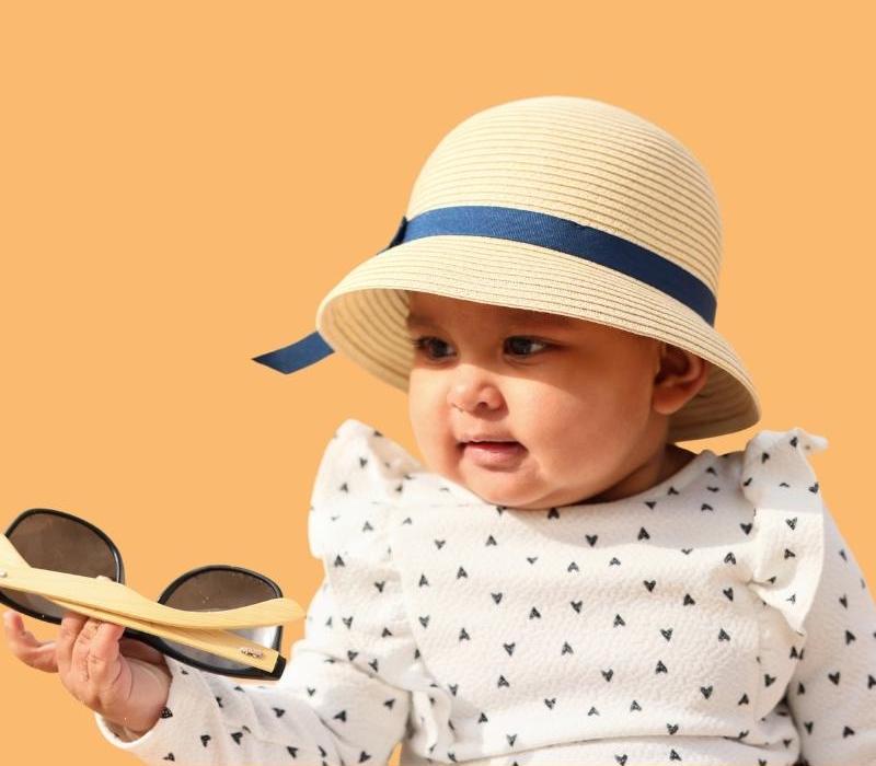 baby wearing hat and long-sleeved clothes for sun safety