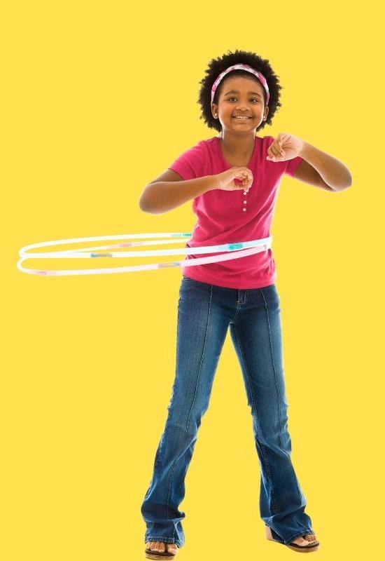 child having fun exercising with a hula hoop