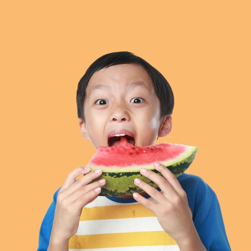 Child about to eat watermelon, wondering where does food go after we eat?