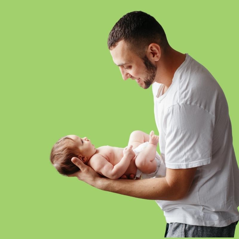 dad holding newborn baby's head for support