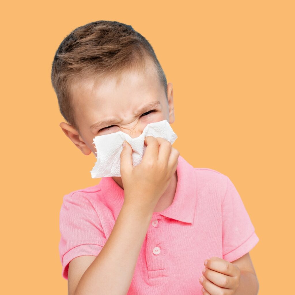 child blowing nose due to runny boogers