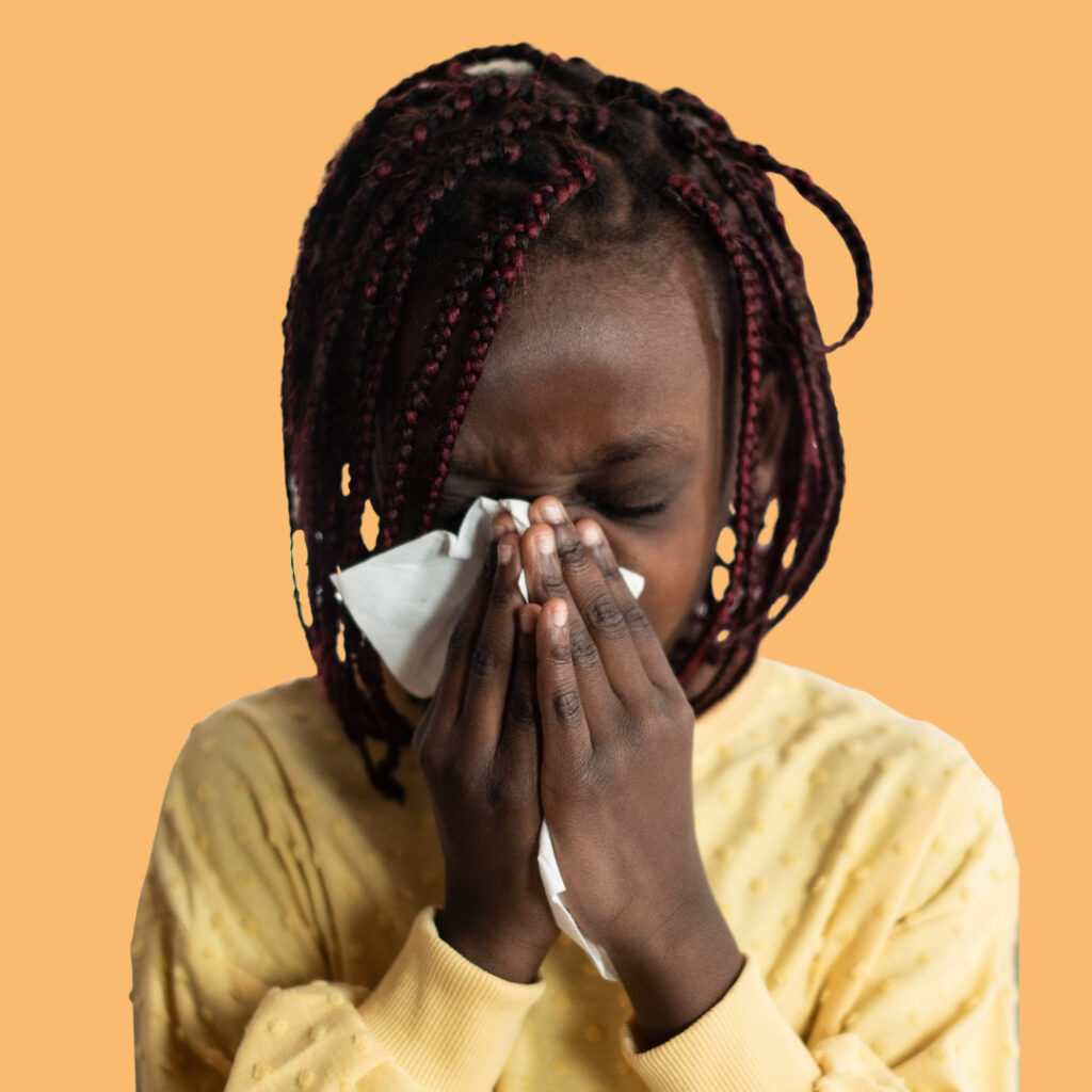 black child blowing nose and feels better